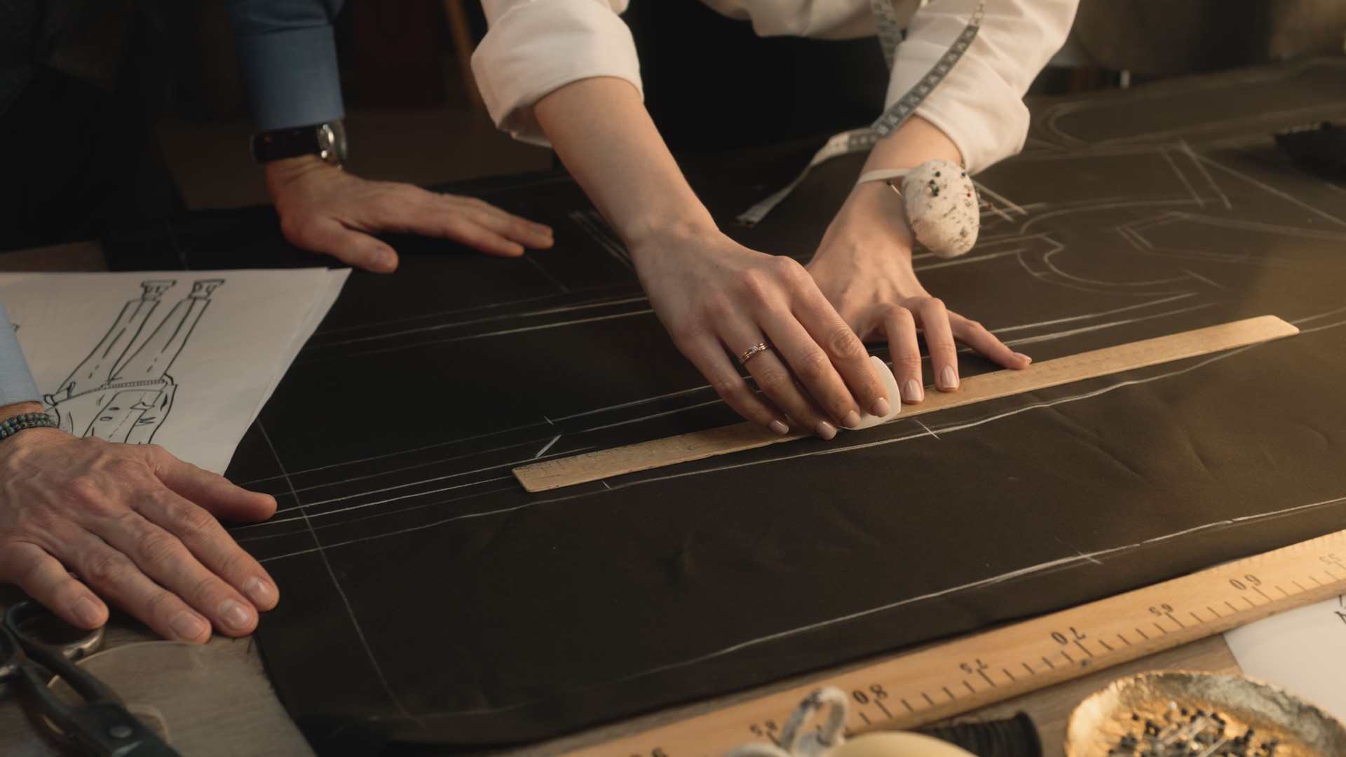 Tailors work on sketch on the textile